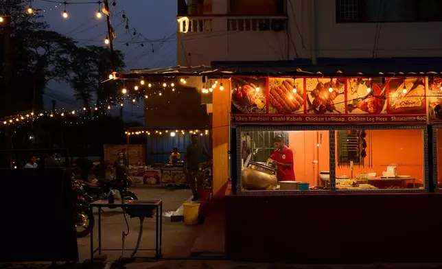 Dusk sets over a restaurant where transgender sex workers meet clients along a busy highway in Hetauda, Nepal, Wednesday, May 20, 2026. (AP Photo/Bram Janssen)