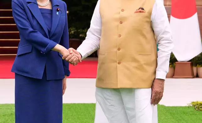 Japanese Prime Minister Sanae Takaichi, left, and Indian Prime Minister Narendra Modi shake hands as they pose for photographs before their delegation level meeting in New Delhi, India, Thursday, July 2, 2026. (AP Photo/Manish Swarup)