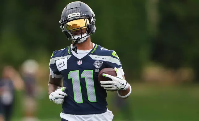 Seattle Seahawks wide receiver Jaxon Smith-Njigba runs the ball during the NFL football team's training camp, Sunday, July 26, 2026, in Renton, Wash. (AP Photo/Lindsey Wasson)