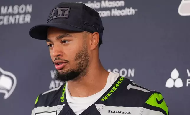 Seattle Seahawks wide receiver Jaxon Smith-Njigba speaks to the media during an availability during the NFL football team's training camp, Sunday, July 26, 2026, in Renton, Wash. (AP Photo/Lindsey Wasson)
