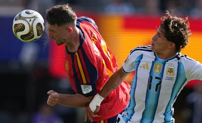Spain's Aymeric Laporte (14) heads the ball past Argentina's Giuliano Simeone (17) during the World Cup final soccer match between Spain and Argentina in East Rutherford, N.J., near New York, Sunday, July 19, 2026. (AP Photo/Frank Franklin II)