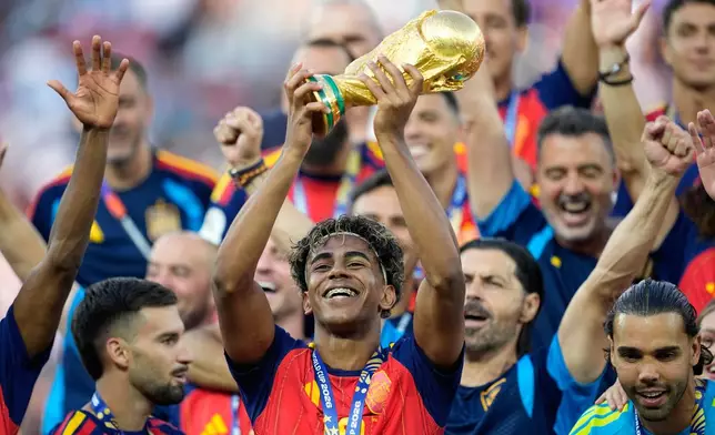 Spain's Lamine Yamal celebrates with the trophy after winning the World Cup final soccer match between Spain and Argentina in East Rutherford, N.J., near New York, Sunday, July 19, 2026. (AP Photo/Ashley Landis)