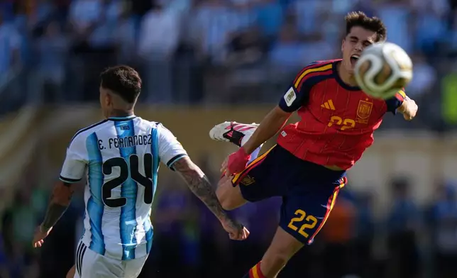 Spain's Pau Cubarsi (22) leaps in the air after he is fouled by Argentina's Enzo Fernandez (24) during the World Cup final soccer match between Spain and Argentina in East Rutherford, N.J., near New York, Sunday, July 19, 2026. (AP Photo/Frank Franklin II)