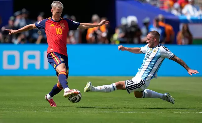 Argentina's Alexis Mac Allister, right, tries to tackle Spain's Dani Olmo during the World Cup final soccer match between Spain and Argentina in East Rutherford, N.J., near New York, Sunday, July 19, 2026. (AP Photo/Ashley Landis)