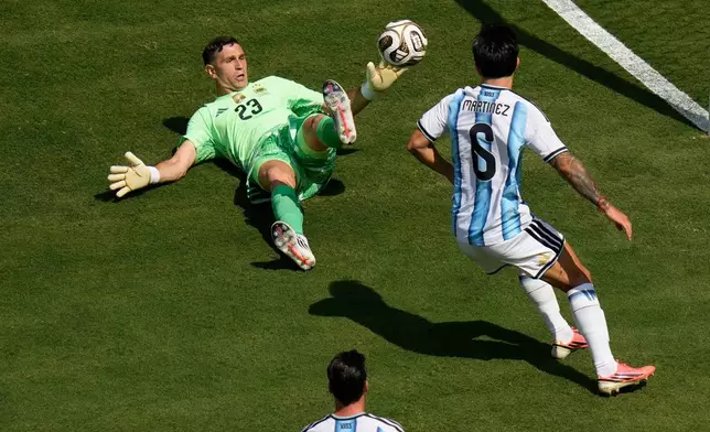 Argentina goalkeeper Emiliano Martinez (23) makes a save during the World Cup final soccer match between Spain and Argentina in East Rutherford, N.J., near New York, Sunday, July 19, 2026. (AP Photo/Seth Wenig)
