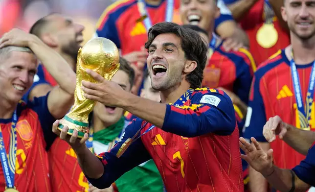 Spain's Ferran Torres celebrates with the trophy after winning the World Cup final soccer match between Spain and Argentina in East Rutherford, N.J., near New York, Sunday, July 19, 2026. (AP Photo/Ashley Landis)