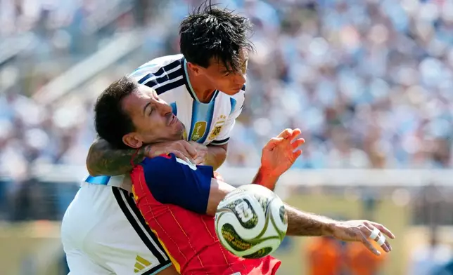 Argentina defender Lisandro Martínez (6) and Spain midfielder Mikel Oyarzabal (21) vie for the ball during first half FIFA World Cup final action, in East Rutherford, N.J., on Saturday, July 19, 2026. (Frank Gunn/The Canadian Press via AP)