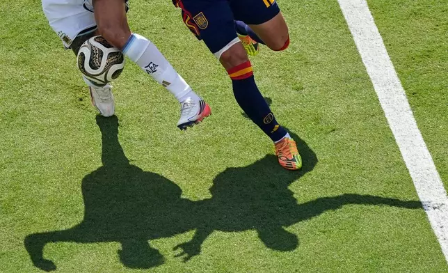 Argentina's Nico Gonzalez (15) challenges for the ball with Spain's Pedro Porro (12) during the World Cup final soccer match between Spain and Argentina in East Rutherford, N.J., near New York, Sunday, July 19, 2026. (AP Photo/Matt Slocum)