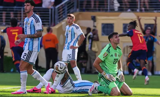 Argentina goalkeeper Emiliano Martinez (23), Marcos Senesi (2) and Nahuel Molina (26) react after Spain's Ferran Torres (7) scores their first goal during the World Cup final soccer match between Spain and Argentina in East Rutherford, N.J., near New York, Sunday, July 19, 2026. (AP Photo/Abbie Parr)