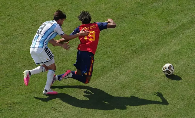 Argentina's Nicolas Tagliafico (3) fouls Spain's Lamine Yamal (19) during the World Cup final soccer match between Spain and Argentina in East Rutherford, N.J., near New York, Sunday, July 19, 2026. (AP Photo/Matt Rourke)