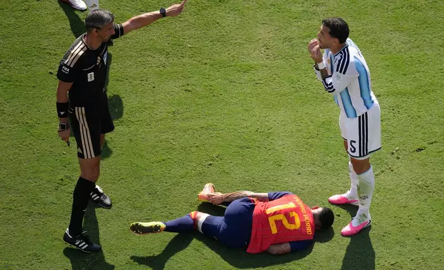 Argentina's Leandro Paredes (5) talks to referee Slavko Vincic of Slovenia after fouling Spain's Pedro Porro (12) during the World Cup final soccer match between Spain and Argentina in East Rutherford, N.J., near New York, Sunday, July 19, 2026. (AP Photo/Matt Slocum)