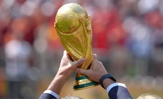 Mario Kempes holds the trophy before the start of the World Cup championship final soccer match between Spain and Argentina in East Rutherford, N.J., Sunday, July 19, 2026. (AP Photo/Jacquelyn Martin)