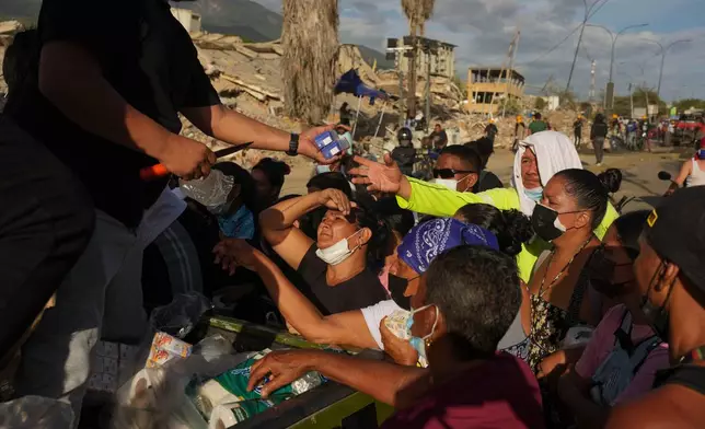 FILE - People affected by the earthquakes line up for food in La Guaira, Venezuela, June 28, 2026. (AP Photo/Matias Delacroix, File)