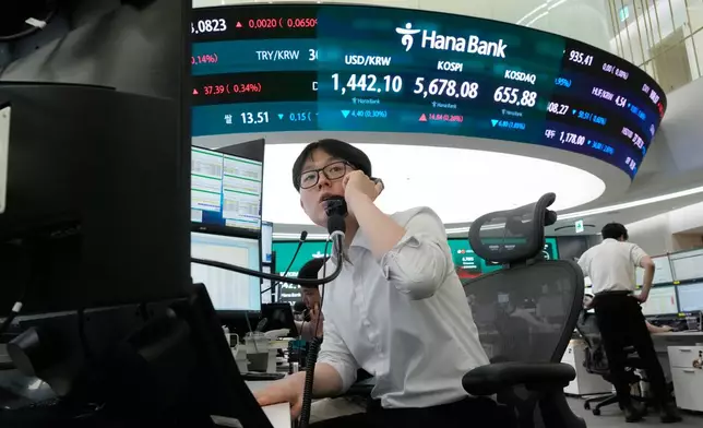A currency trader talks on the phone at the foreign exchange dealing room of the Hana Bank headquarters in Seoul, South Korea, Thursday, July 30, 2026. (AP Photo/Ahn Young-joon)