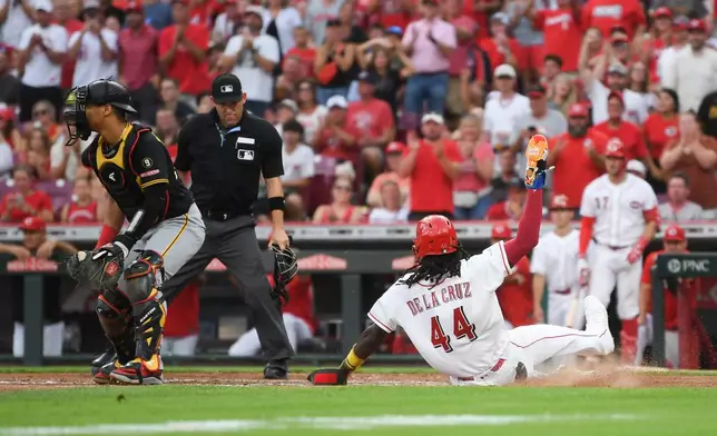Cincinnati Reds' Elly de la Cruz scores after single by Sal Stewart during the third inning of a baseball game against the Pittsburgh Pirates on Thursday, July 30, 2026 in Cincinnati. (AP Photo/Tanner Pearson)