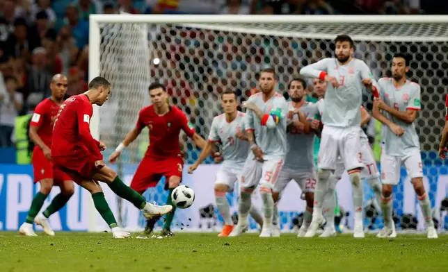 FILE - Portugal's Cristiano Ronaldo kicks to score his side's equalizing goal during the group B World Cup match between against Spain in Sochi, Russia, Friday, June 15, 2018. (AP Photo/Francisco Seco, File)