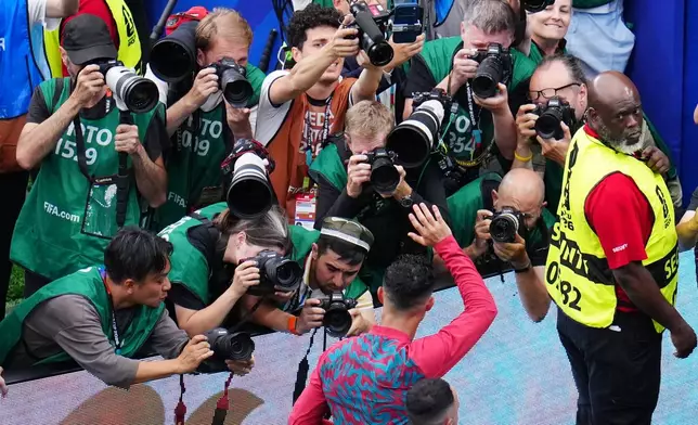 FILE - Photographers capture Portugal's Cristiano Ronaldo (7) leaving the pitch after the World Cup Group K soccer match between Portugal and Uzbekistan in Houston, June 23, 2026. (AP Photo/Karen Warren, File)