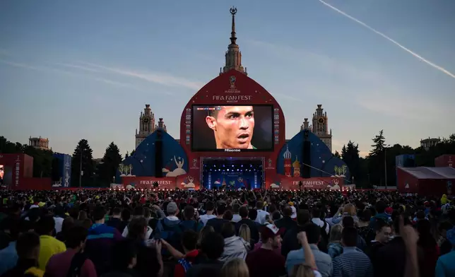 FILE - Fans watch on a giant screen as Portugal's Cristiano Ronaldo prepares to kick a penalty during the group B match between Portugal and Spain, at the FIFA Fan Fest in Moscow, Russia, June 15, 2018. (AP Photo/Felipe Dana, File)