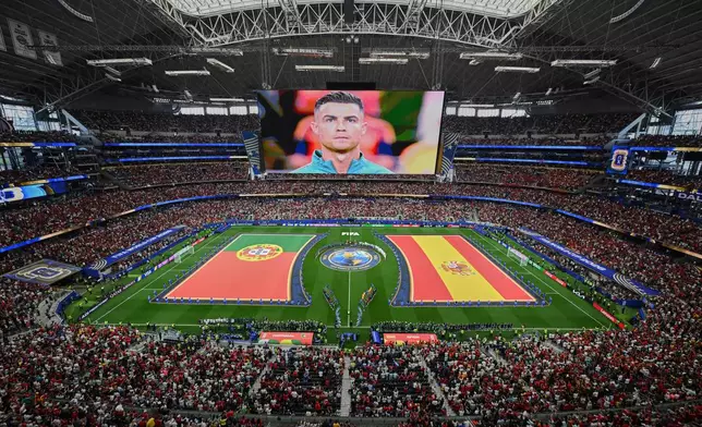 Flags for Portugal and Spain are displayed as Portugal's Cristiano Ronaldo is seen on a screen ahead of the ahead the World Cup round of 16 soccer match between Portugal and Spain in Arlington, Texas, near Dallas, Monday, July 6, 2026. (AP Photo/Jessica Tobias)