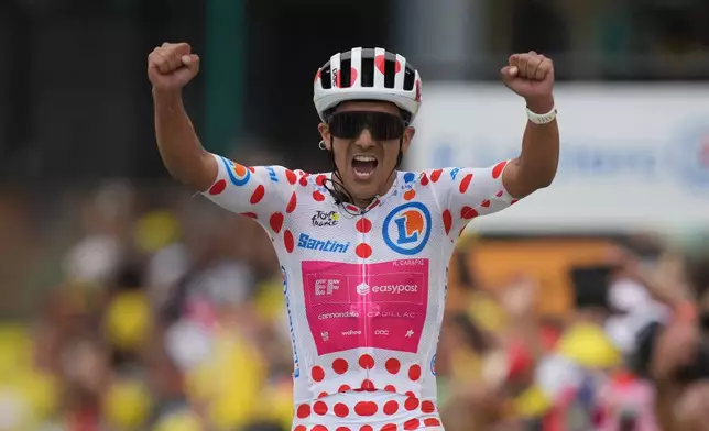 Ecuador's Richard Carapaz celebrates as he crosses the finish line to win the twentieth stage of the Tour de France cycling race with start in Le Bourg d'Oisans and finish in Alpe d'huez, France, Saturday, July 25, 2026. (AP Photo/Mosa'ab Elshamy)