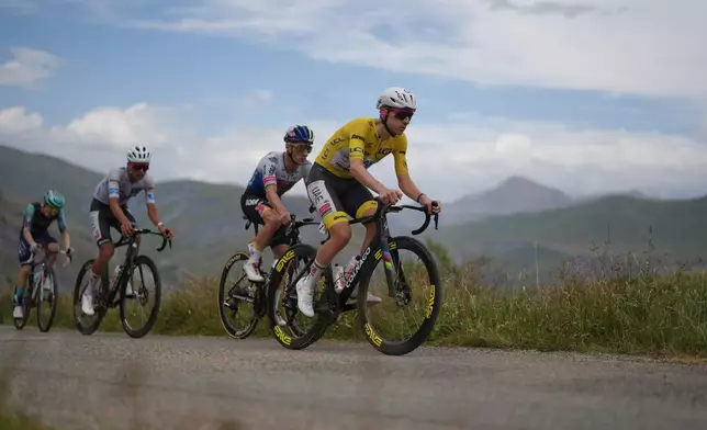 Slovenia's Tadej Pogacar climbs the Sarenne pass ahead of Belgium's Remco Evenepoel, center, and Mexico's Isaac Del Toro, left, during the twentieth stage of the Tour de France cycling race with start in Le Bourg d'Oisans and finish in Alpe d'huez, France, Saturday, July 25, 2026. (AP Photo/Thibault Camus)