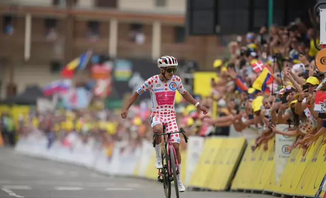 Ecuador's Richard Carapaz celebrates as he crosses the finish line to win the twentieth stage of the Tour de France cycling race with start in Le Bourg d'Oisans and finish in Alpe d'huez, France, Saturday, July 25, 2026. (AP Photo/Mosa'ab Elshamy)