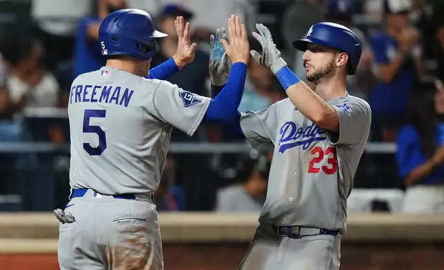 Los Angeles Dodgers' Kyle Tucker (23) celebrates with Freddie Freeman (5) after they scored on two-run home run by Tucker during the eighth inning of a baseball game against the New York Mets Friday, July 24, 2026, in New York. (AP Photo/Frank Franklin II)