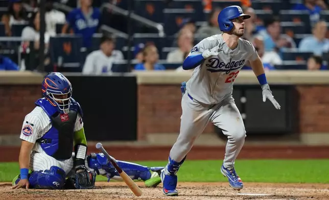 New York Mets catcher Francisco Alvarez, left, reacts as Los Angeles Dodgers' Kyle Tucker follows through on a two-run home run during the eighth inning of a baseball game Friday, July 24, 2026, in New York. (AP Photo/Frank Franklin II)
