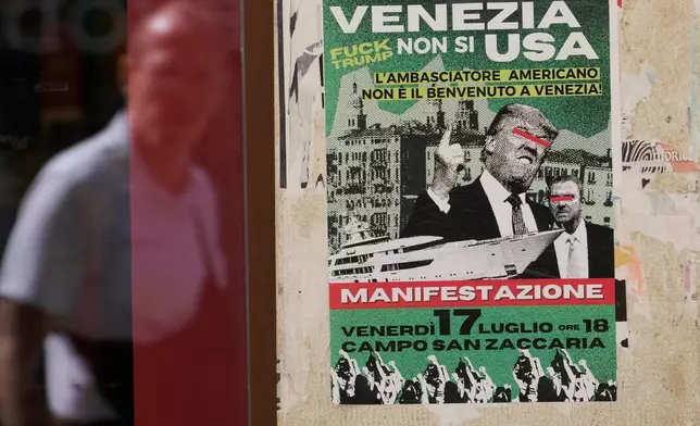 A poster of the protest against U.S. Ambassador Tilman Fertitta's superyacht 'Boardwall' presence, hangs on a wall in Venice, Friday, July 17, 2026. (AP Photo/Luca Bruno)