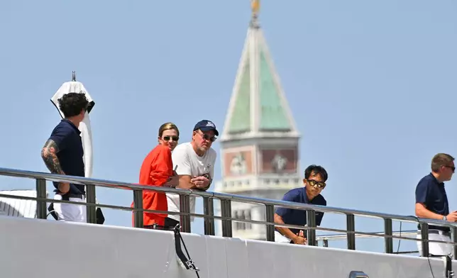 U.S. Ambassador to Italy Tilman Fertitta, center, with his wife Lauren Ware, second from left, is backdropped by the bell tower of St. Mark's Basilica upon arrival in Venice, Italy, Friday, July 17, 2026, aboard his super yacht, Boardwalk, as part of his "Freedom 250 Coastal Diplomacy" tour.(AP Photo/Luigi Costantini)