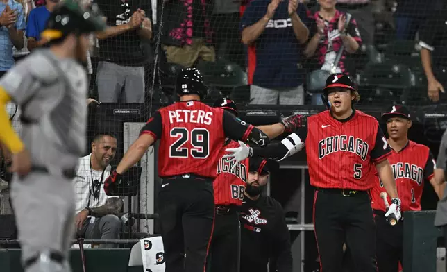 Chicago White Sox's Tristan Peters (29) celebrates with teammate Munetaka Murakami (5) at the dugout after hitting a two-run home run during the seventh inning of a baseball game against The Athletics in Chicago, Friday, July 10, 2026. (AP Photo/Paul Beaty)