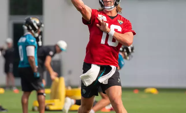 Jacksonville Jaguars quarterback Trevor Lawrence, (16) throws a pass during practice at the team's NFL football training camp, Wednesday, July 29, 2026, in Jacksonville, Fla. (AP Photo/Kelly Jordan)