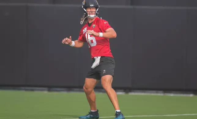 Jacksonville Jaguars quartback Trevor Lawrence (16), stretches during practice at the team's NFL football training camp, Wednesday, July 29, 2026, in Jacksonville, Fla. (AP Photo/Kelly Jordan)
