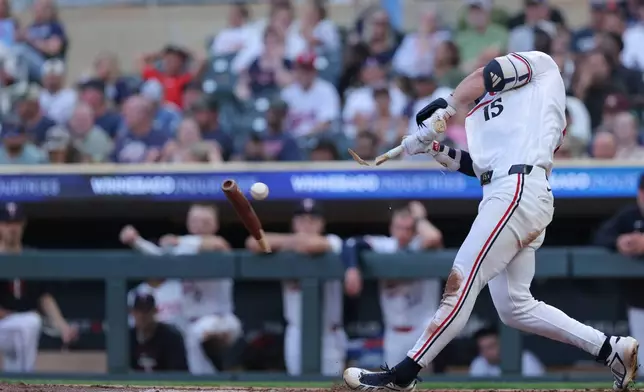 Minnesota Twins' Luke Keaschall breaks his bat resulting in a single during the sixth inning of a baseball game against the Cleveland Guardians, Tuesday, July 7, 2026, in Minneapolis. (AP Photo/Bailey Hillesheim)