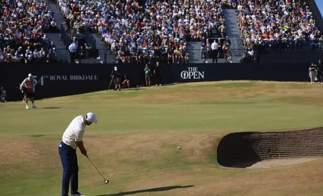 Scottie Scheffler of the United States putts onto the 18th green during the final day of the British Open Golf championships at Royal Birkdale golf club, in Southport, England, Sunday, July 19, 2026. (AP Photo/Peter Morrison)
