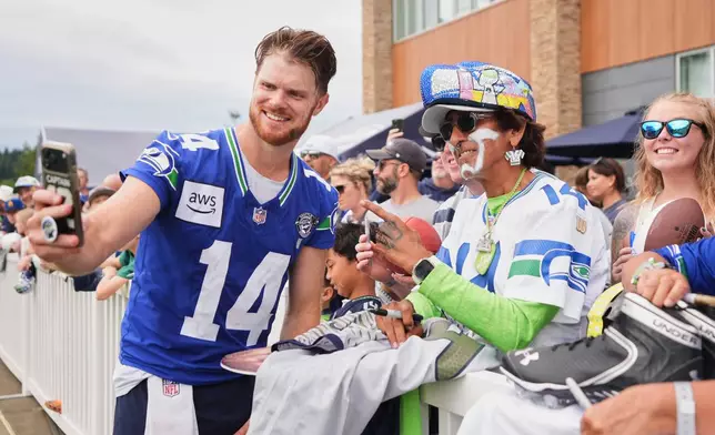 Seattle Seahawks quarterback Sam Darnold takes a selfie during the NFL football team's training camp, Sunday, July 26, 2026, in Renton, Wash. (AP Photo/Lindsey Wasson)