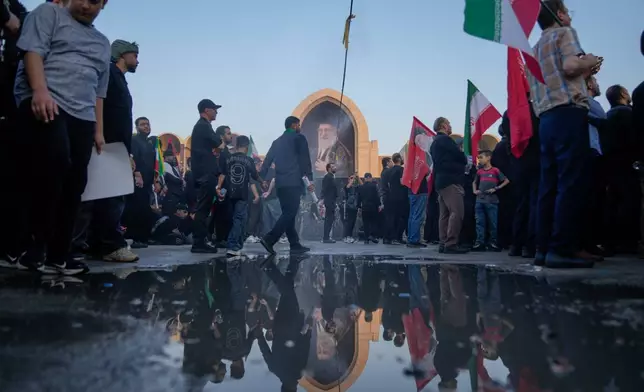 Mourners walk through the grounds of the Imam Khomeini Mosalla Grand Mosque during the funeral ceremonies for slain Iranian Supreme Leader Ayatollah Ali Khamenei and members of his family in Tehran, Iran, Saturday, July 4, 2026. (AP Photo/Altaf Qadri)