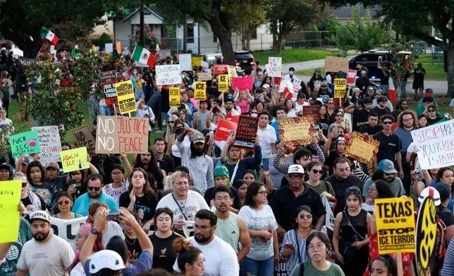 People march during a vigil for Lorenzo Salgado Araujo, a Mexican national fatally shot by a federal immigration agent a day prior, Wednesday, July 8, 2026, in Houston. (AP Photo/Mark Felix)