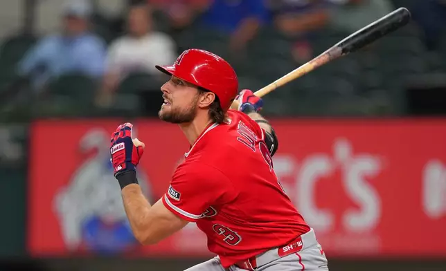 Los Angeles Angels' Josh Lowe watches his ball as he hits an RBI single to score Jorge Soler against the Texas Rangers during the first inning of a baseball game, Tuesday, July 7, 2026, in Arlington, Texas. (AP Photo/Julio Cortez)