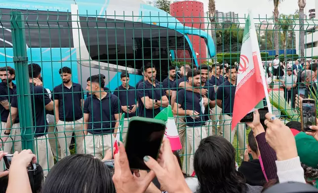 Fans greet members of the Iran World Cup soccer team as they leave their hotel for the airport Tuesday, June 30, 2026, in Tijuana, Mexico. (AP Photo/Gregory Bull)