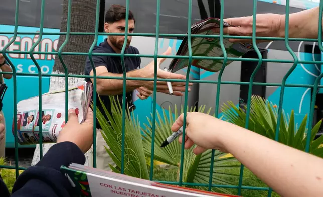 Iran's Alireza Jahanbakhsh greets fans and signs autographs as the Iran World Cup soccer team leaves their hotel for the airport Tuesday, June 30, 2026, in Tijuana, Mexico. (AP Photo/Gregory Bull)