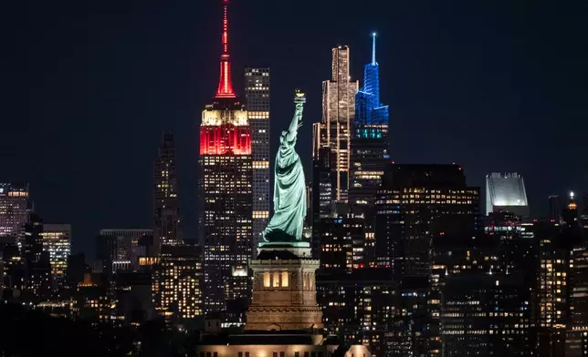 Statue of Liberty stands next to Empire State Building, left, in New York, as seen from Jersey City, N.J., Sunday, May 31, 2026 (AP Photo/Yuki Iwamura)