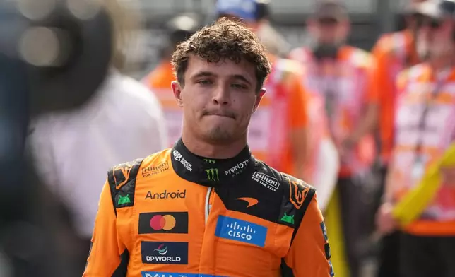 McLaren driver Lando Norris of Britain walks after winning the qualifying session ahead of Sunday's Formula One Hungarian Grand Prix auto race, at the Hungaroring racetrack in Mogyorod, near Budapest, Hungary, Saturday, July 25, 2026. (AP Photo/Darko Vojinovic)
