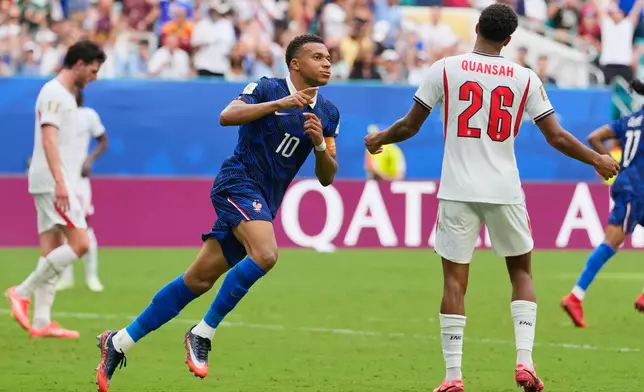 France's Kylian Mbappe (10) celebrates scoring his side's third goal as England's Jarell Quansah (26) reacts to the score during the World Cup third-place playoff soccer match between France and England in Miami Gardens, Fla., Saturday, July 18, 2026. (AP Photo/Rebecca Blackwell)