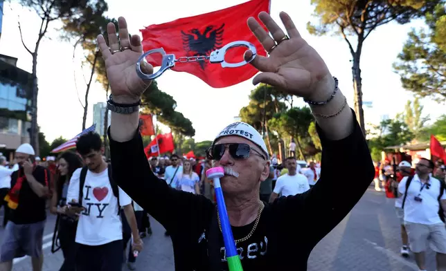 A protester takes part in a rally against plans for a luxury construction project linked to U.S. President Donald Trump's son-in-law, Jared Kushner, in Tirana, Albania, Saturday, July 4, 2026.(AP Photo/Hameraldi Agolli)