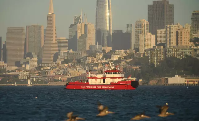 A San Francisco Fire Department vessel passes the city skyline while searching for missing victims after a boat accident near Alcatraz Island off San Francisco, Tuesday, July 14, 2026. (AP Photo/Noah Berger)