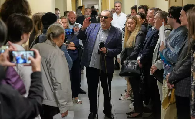 Russian politician Boris Nadezhdin, accused of displaying "extremist symbols," speaks to journalists as he arrives at the courtroom in the town of Dolgoprudny outside Moscow, Russia, Friday, July 17, 2026. (AP Photo/Pavel Bednyakov)