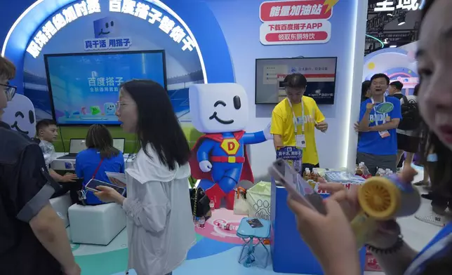 Visitors at the booth for Baidu's AI Agent Dumate during the World AI Conference in Shanghai, China on July 17, 2026. (AP Photo/Ng Han Guan)