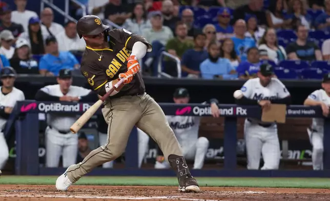 San Diego Padres' Ty France hits a two-run single against the Miami Marlins during the third inning of a baseball game, Saturday, July 25, 2026, in Miami. (AP Photo/David Santiago)