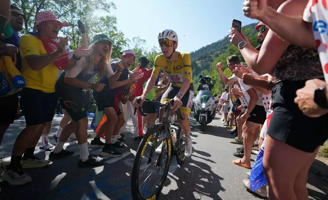 Slovenia's Tadej Pogacar, wearing the overall leader's yellow jersey, climbs Alpe d'Huez during the nineteenth stage of the Tour de France cycling race with start in Gap and finish in Alpe d'Huez, France, Friday, July 24, 2026. (AP Photo/Mosa'ab Elshamy)
